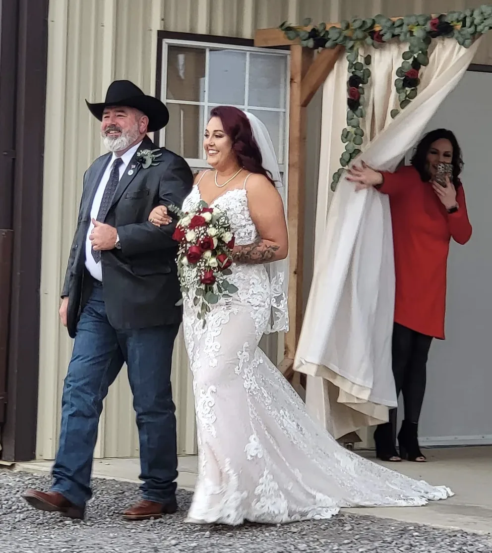 Father in a cowboy hat escorting his daughter down the aisle at a Texas country wedding venue near Bryan and College Station