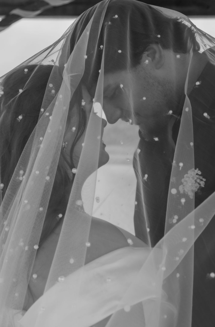 Jaelyn & Keelan's wedding at Reverie at Diamond D — black-and-white close-up of the couple beneath the pearl-studded veil
