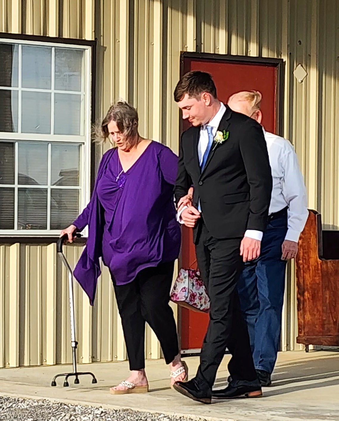 Groom escorting his grandmother into the barn before the ceremony at Reverie at Diamond D