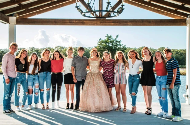Sweet 16 honoree with friends on the lakeside pavilion dock at Reverie at Diamond D