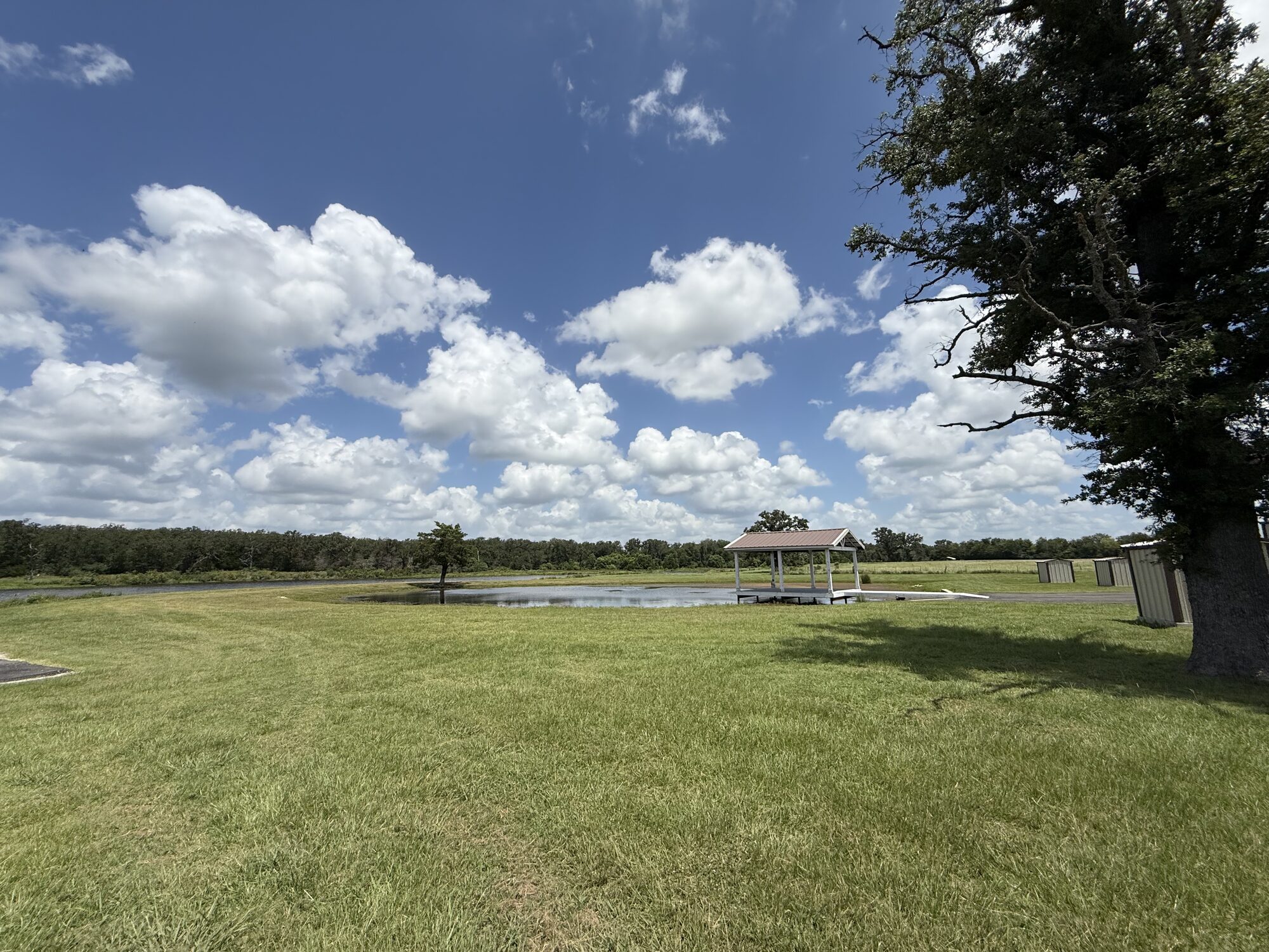 Covered lakeside ceremony pavilion over the nine-acre lake at Reverie at Diamond D