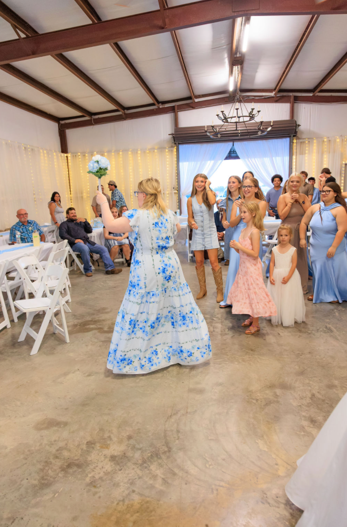 Jaelyn & Keelan's wedding at Reverie at Diamond D — the bouquet toss to the single ladies in the reception barn