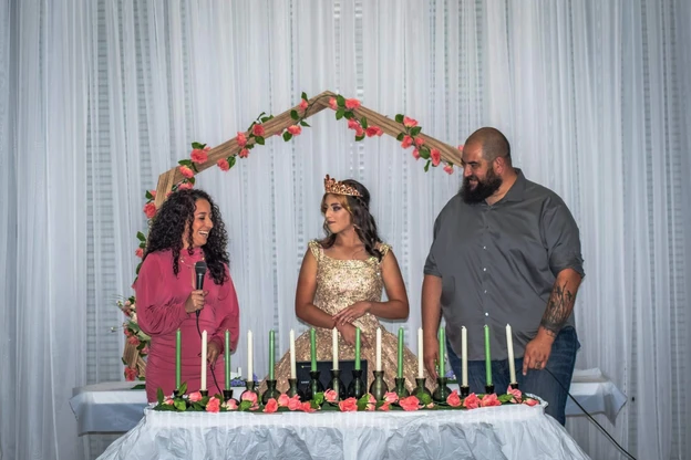 Candle lighting ceremony toast under the coral floral arch at Bryanna's Sweet 16
