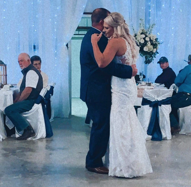 Bride and groom's first dance in front of a sparkling twinkle-light curtain