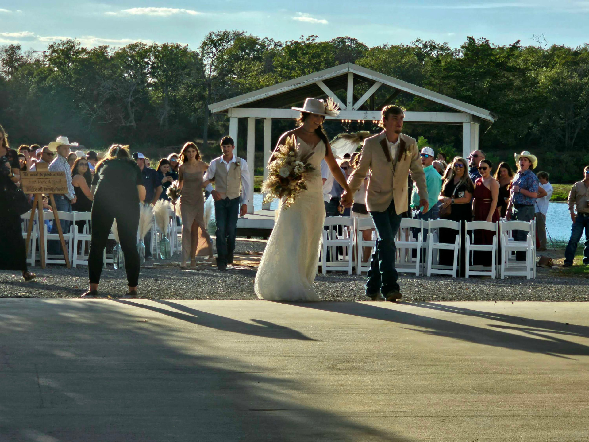 Newlyweds walking back up the aisle after a Texas ranch wedding ceremony at Reverie at Diamond D