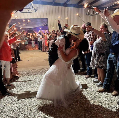 Bride and groom kissing during their wedding send-off at Reverie at Diamond D