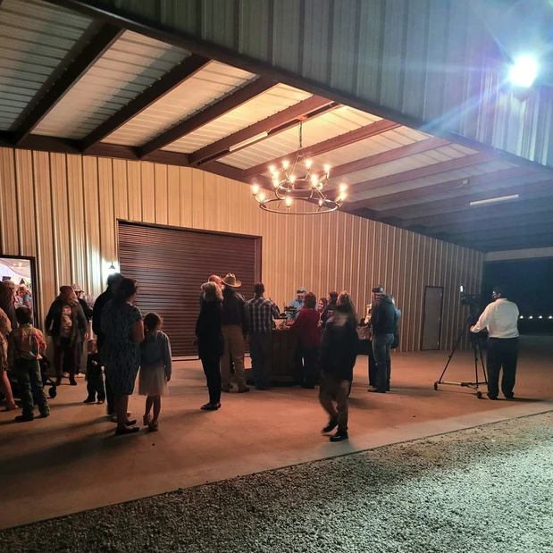 Covered lakeside pavilion set for an evening gathering at Reverie at Diamond D, a Central Texas retreat venue