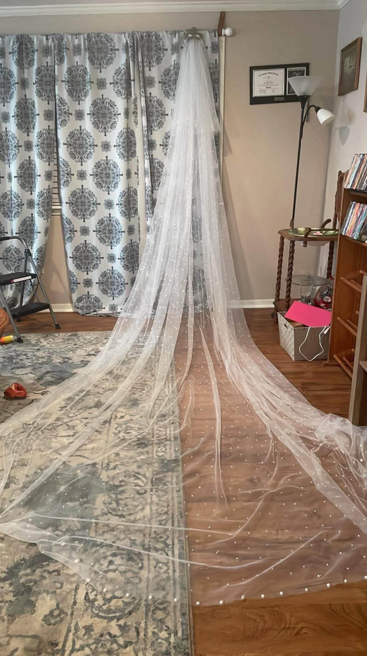 Jaelyn & Keelan's wedding at Reverie at Diamond D — the bride's long pearl-studded cathedral veil displayed in the bridal suite