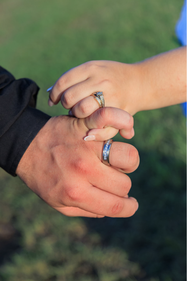Jaelyn & Keelan's wedding at Reverie at Diamond D — the couple's hands showing their wedding bands
