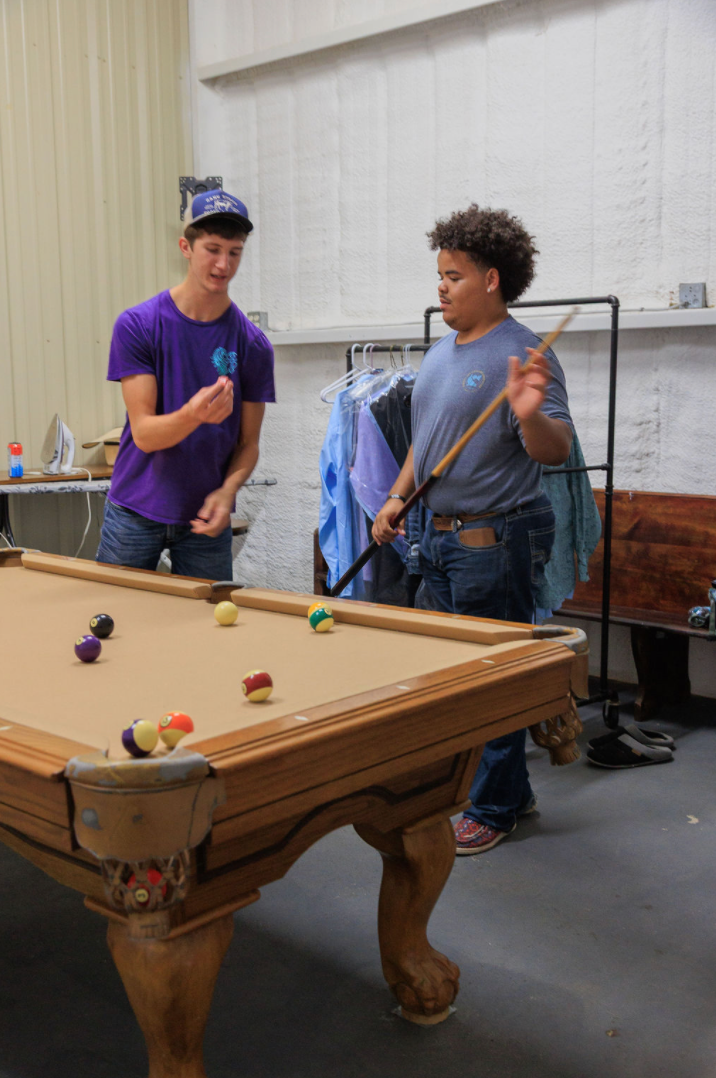 Jaelyn & Keelan's wedding at Reverie at Diamond D — groomsmen playing pool in the groom suite before the ceremony