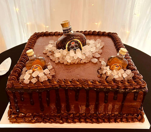 Chocolate groom's cake decorated with whiskey bottles at a Reverie at Diamond D reception