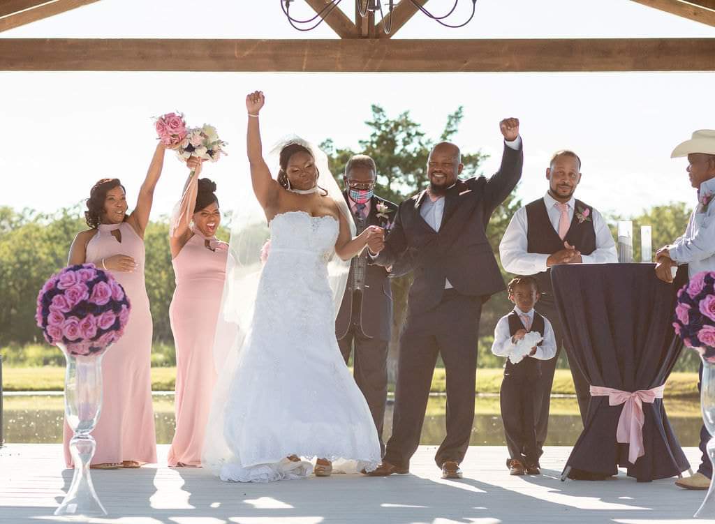 Newlyweds and bridesmaids cheering after the pavilion ceremony