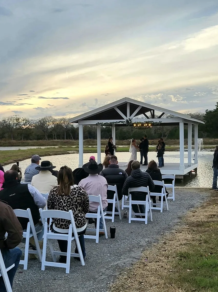 Tate and Jackie's outdoor wedding ceremony at the lakeside pavilion gazebo at Reverie at Diamond D in Normangee, Texas