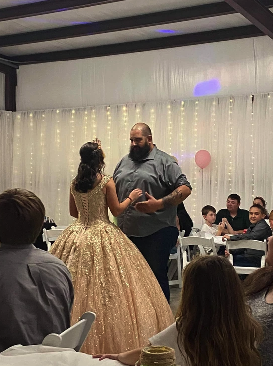 Father and daughter dance in front of the twinkle-light draped wall at Bryanna's Sweet 16
