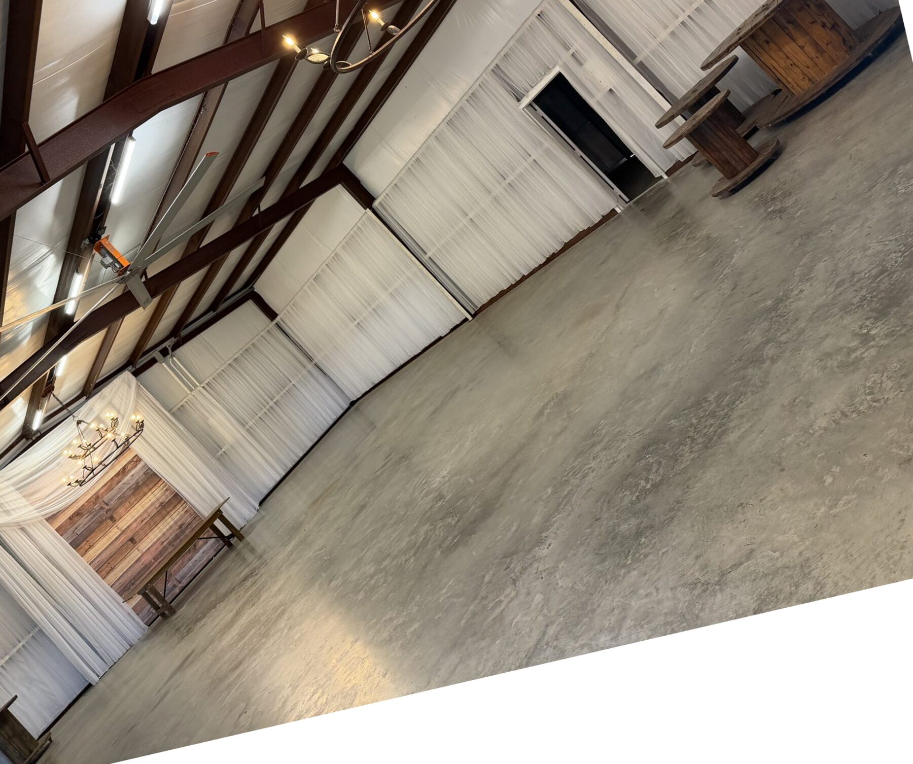 Draped barn reception hall set for a wedding at Reverie at Diamond D in Normangee, Texas