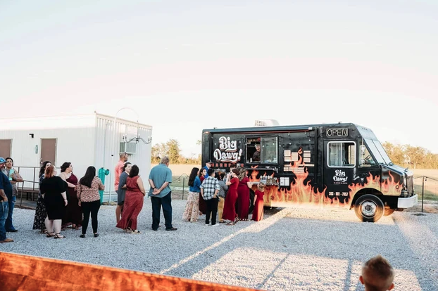 Guests lined up at the Big Dawg food truck outside the venue at sunset