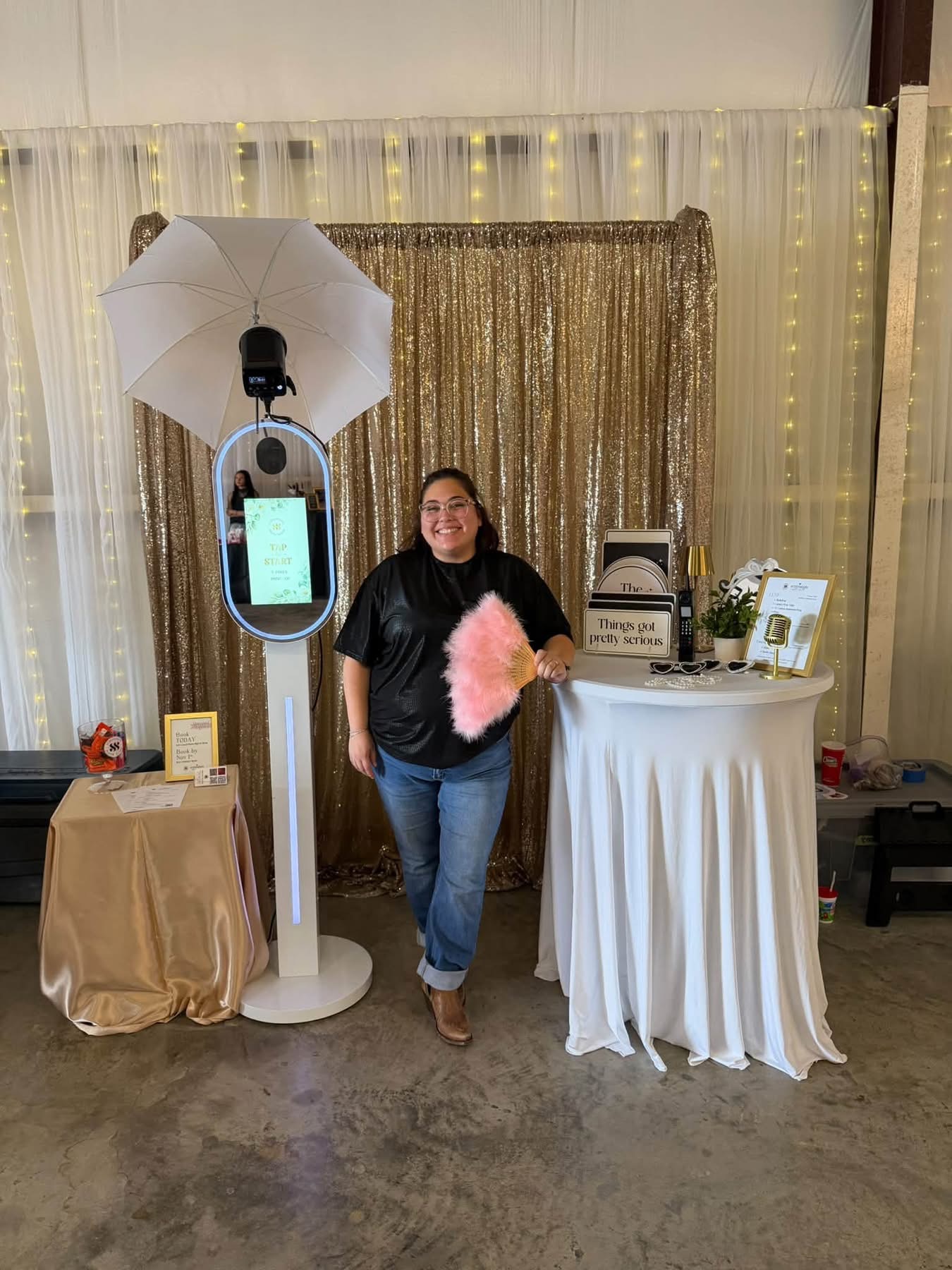 October 2026 Open House at Reverie at Diamond D wedding venue in Normangee, Texas — a photo booth with a gold sequin backdrop, props and a ring-light mirror station