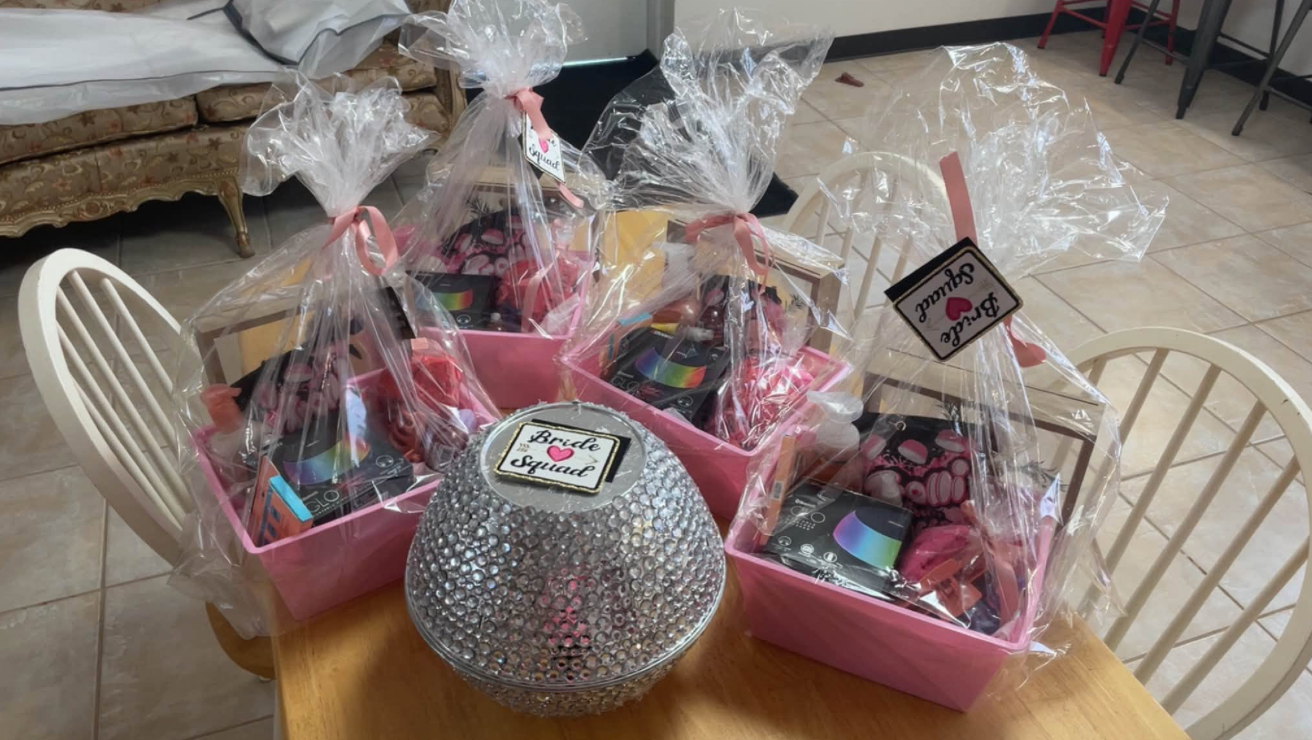 Jaelyn & Keelan's wedding at Reverie at Diamond D — "Bride Squad" gift bags arranged on a table while the bridal party gets ready