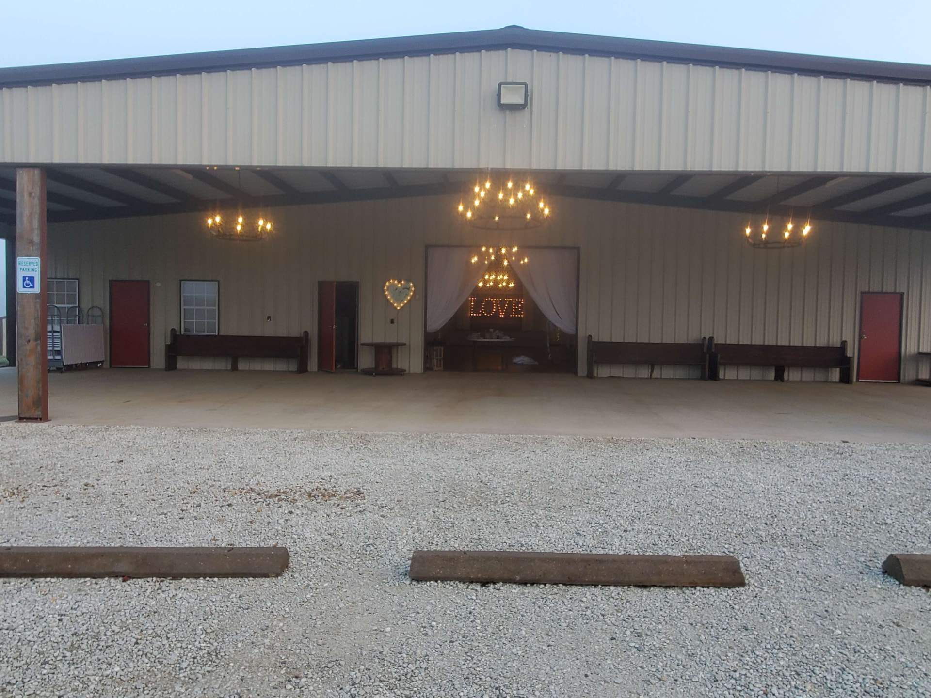 Covered barn porch with the marquee love sign at Reverie at Diamond D wedding venue in Normangee, Texas