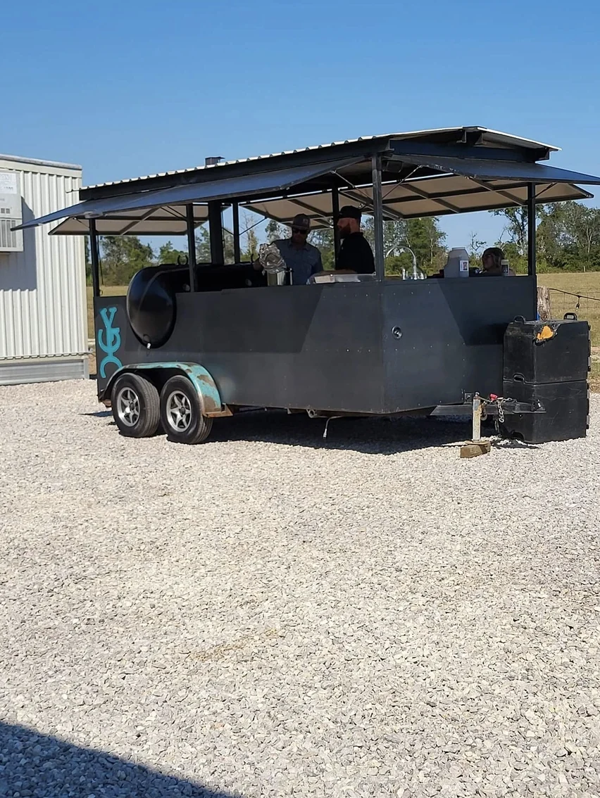 Mobile catering trailer parked on the gravel while the catering team serves a Texas ranch wedding