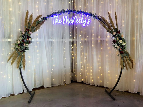 Neon love sign and floral backdrop from the decor library available for private events in Normangee, Texas