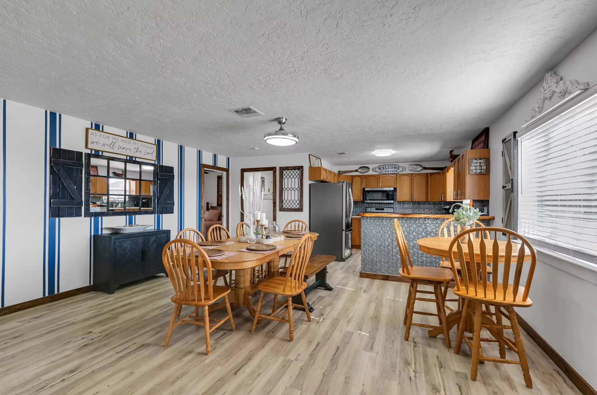 Farmhouse dining room with a long table, breakfast table and open kitchen at Reverie at Diamond D