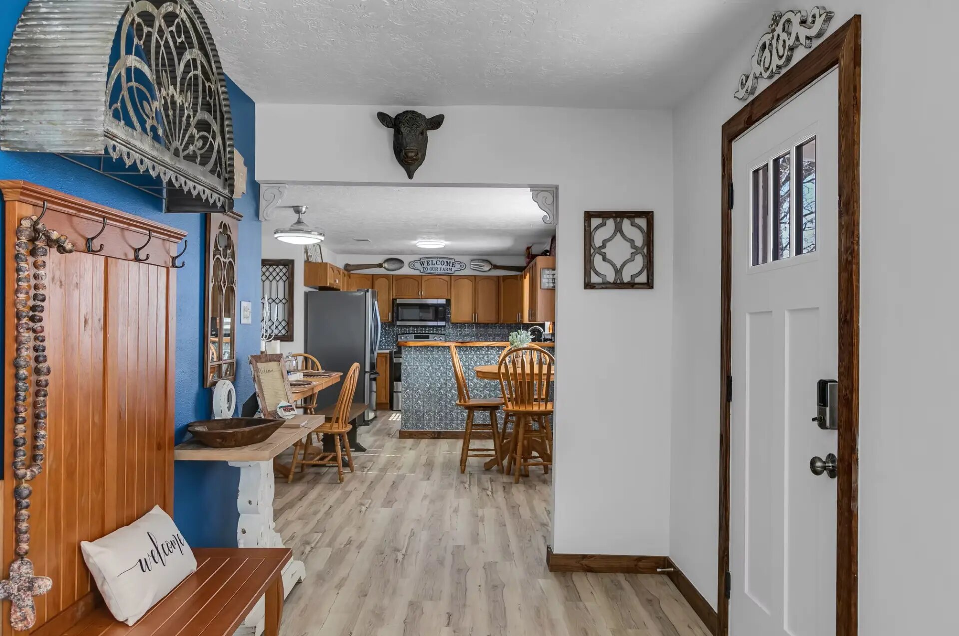 Front entry of the farmhouse looking through to the kitchen and dining area at Reverie at Diamond D