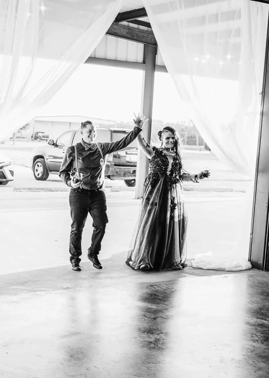 Black and white grand entrance through the draped pavilion doors into the reception