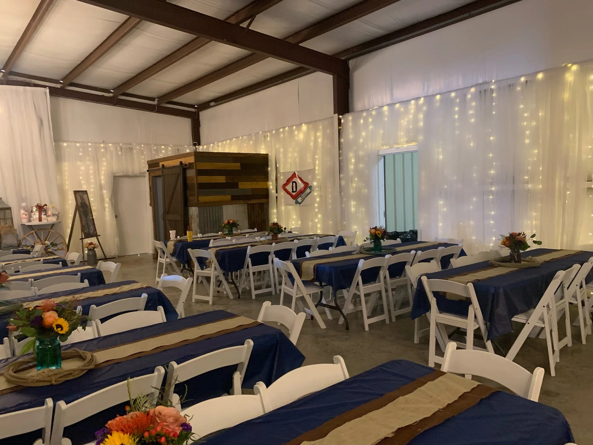 Guest tables and seating arranged across the event hall at Reverie at Diamond D, a private meeting venue in Normangee, Texas