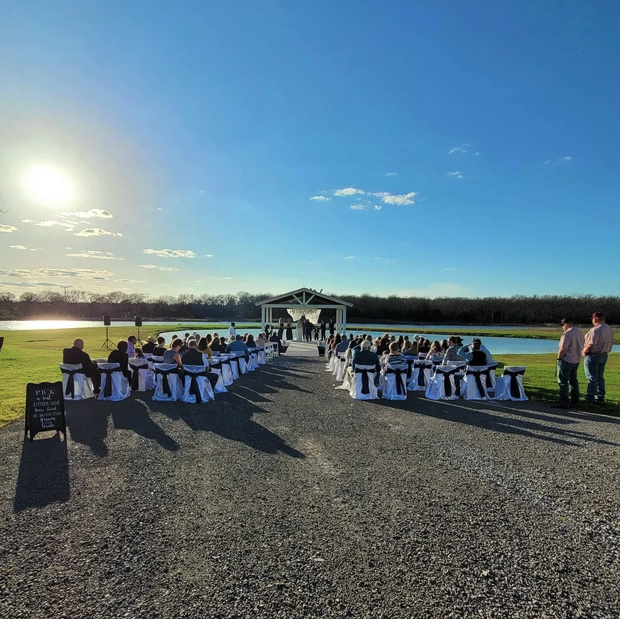 Lakeside wedding ceremony at Reverie at Diamond D, a wedding venue near Bryan and College Station, Texas.