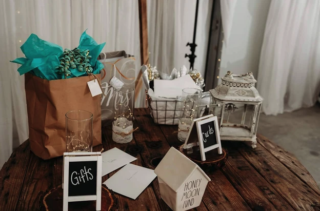 Rustic gift and card table with lanterns, chalkboard signs and a honeymoon fund box