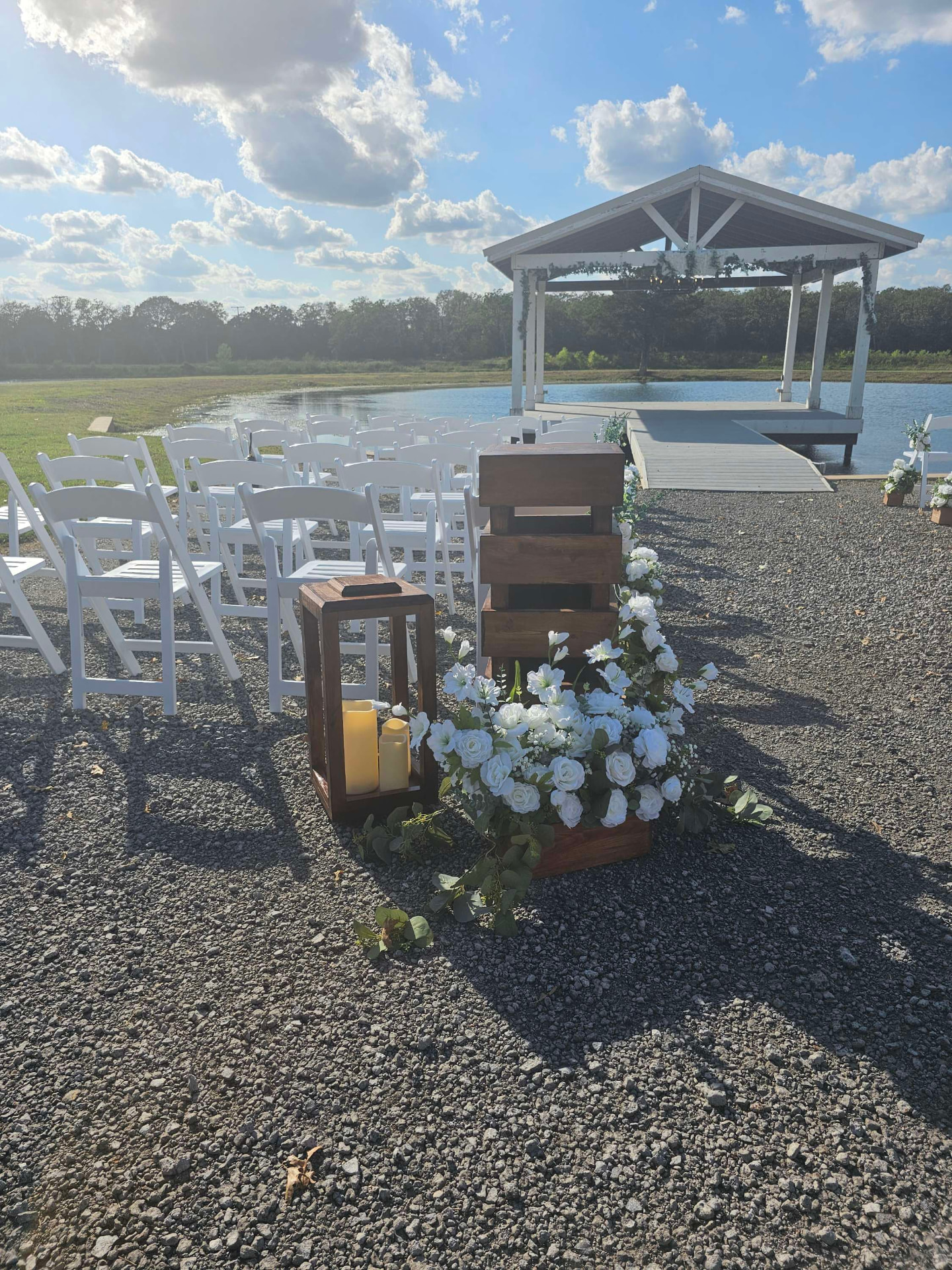 Outdoor wedding ceremony setup beside the lake at Reverie at Diamond D in Normangee, Texas