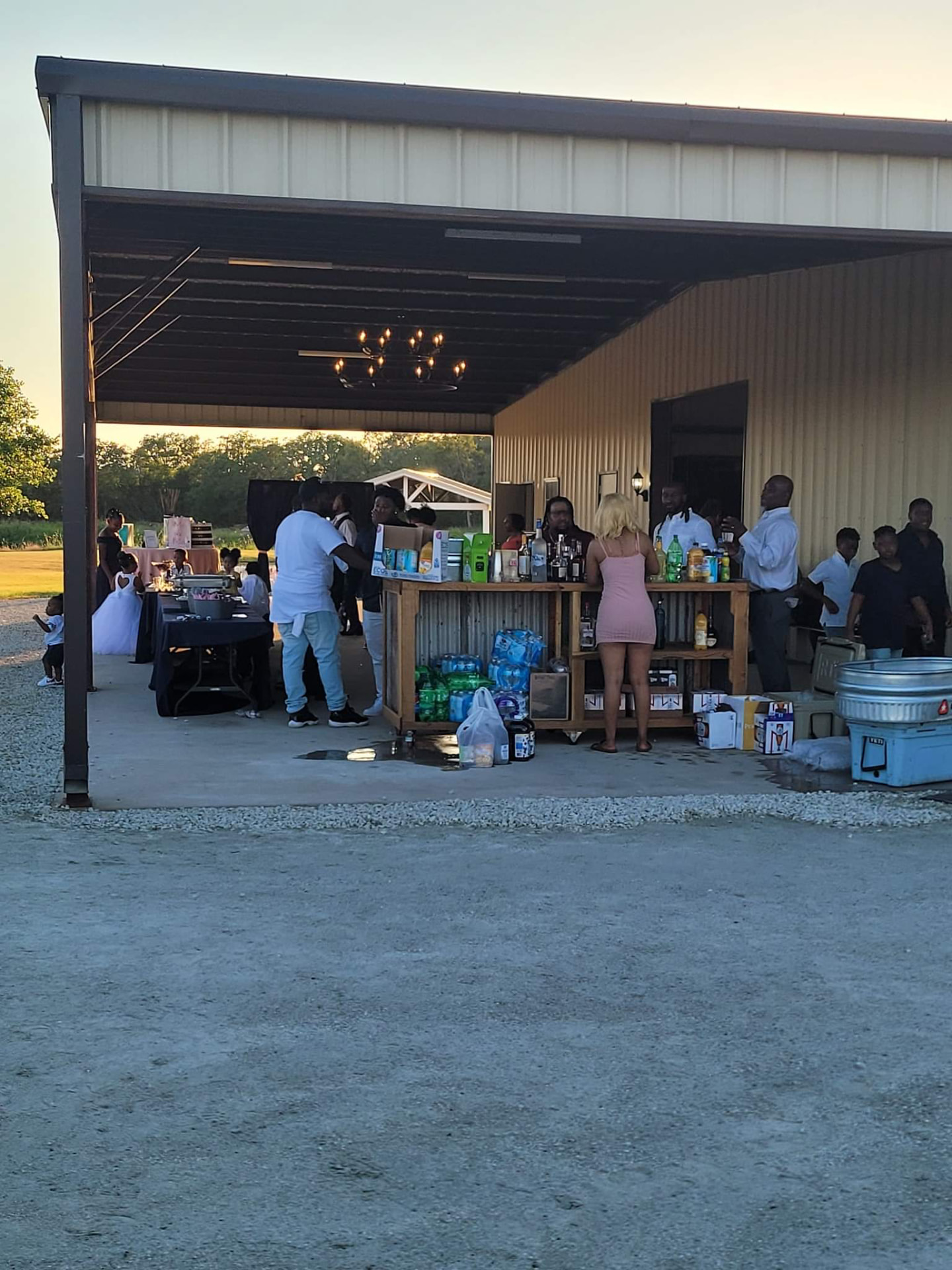 Guests gathered at the covered patio bar at golden hour