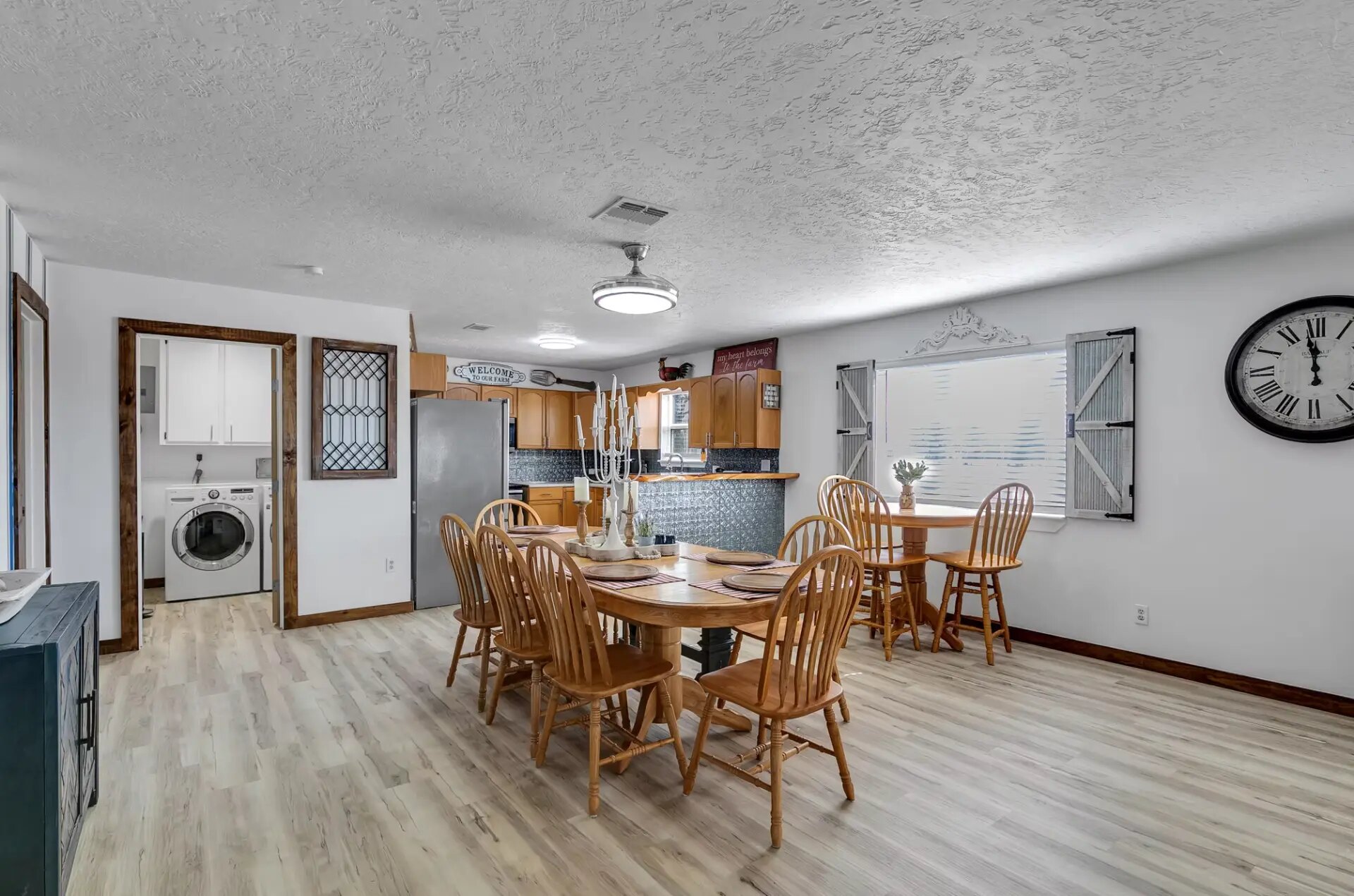 Farmhouse dining area with breakfast table and the laundry room off the kitchen at Reverie at Diamond D