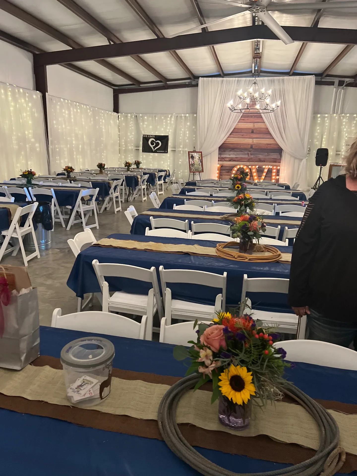 Navy-draped banquet tables arranged in the barn for a group session at Reverie at Diamond D in Normangee, Texas