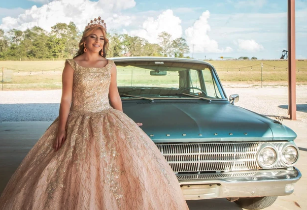 Sweet 16 portrait beside a vintage teal car on the Reverie at Diamond D property