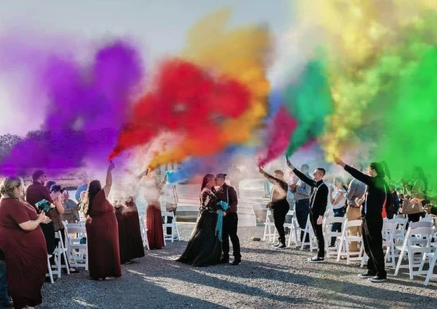 Rainbow smoke bomb send-off as Candace and Chelsea kiss in the aisle after their ceremony