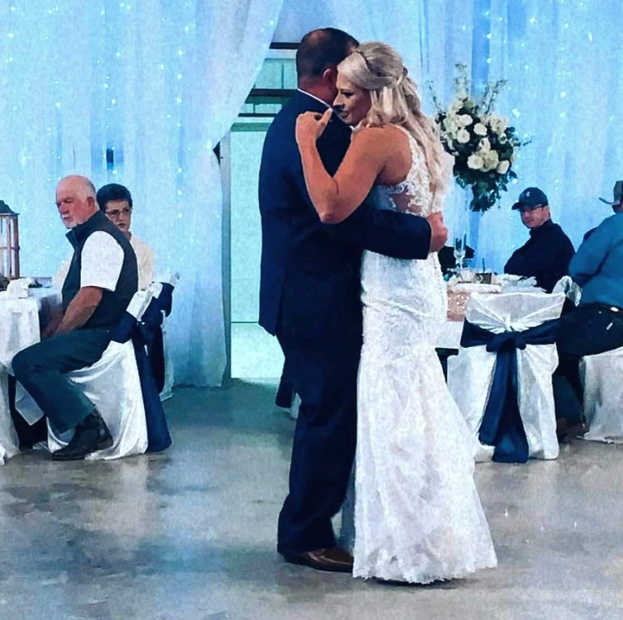 Bride and groom sharing their first dance in front of a twinkle-light backdrop