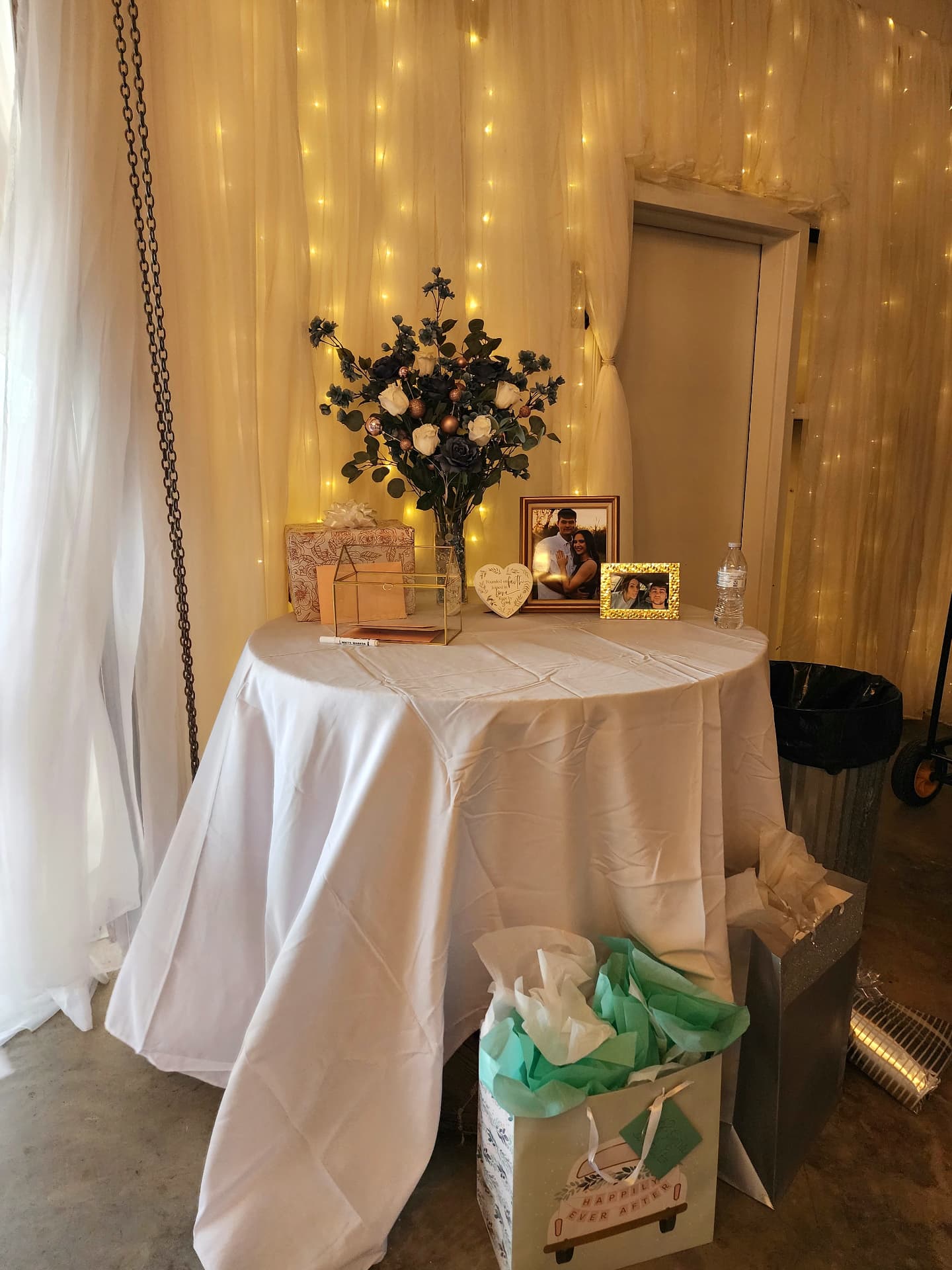 Gift and memory table with florals, photo frames and card box at a barn reception