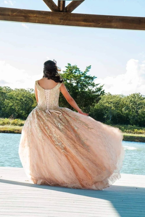 Rose gold gown train sweeping across the lake dock at Bryanna's Sweet 16 in Normangee, Texas