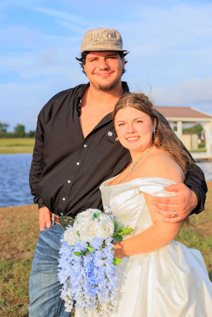 Jaelyn and Keelan's couple portrait beside the lake at Reverie at Diamond D wedding venue in Normangee, Texas