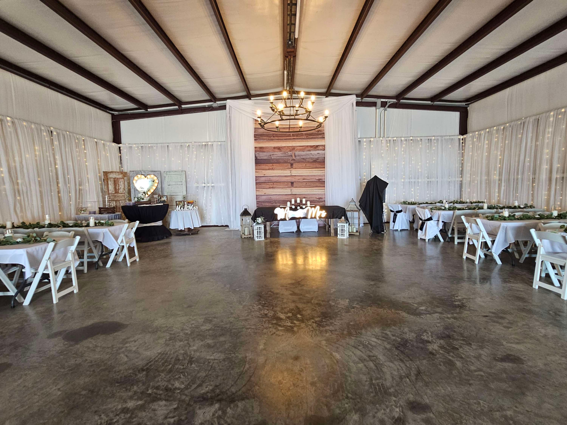 Barn head table set with included tables, chairs and draping at Reverie at Diamond D in Normangee, Texas