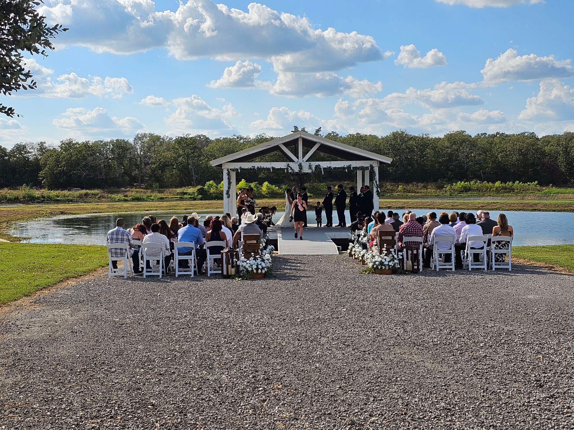 Lakeside wedding ceremony at sunset at Reverie at Diamond D in Normangee, Texas