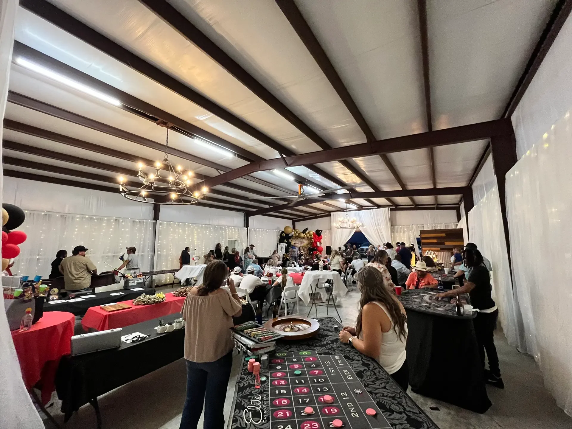 Guests gathered around casino tables during the Love Like Bailin Therapy Farm event at Reverie at Diamond D in Normangee, Texas