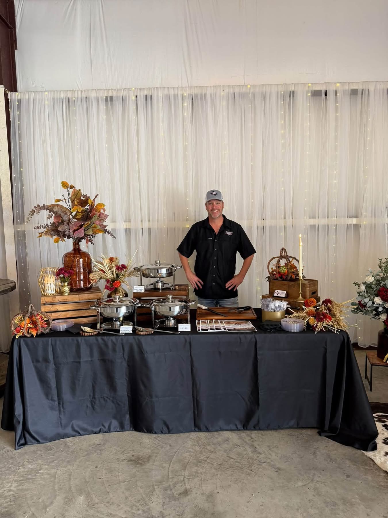 October 2026 Open House at Reverie at Diamond D wedding venue in Normangee, Texas — a catering booth with chafing dishes and fall floral arrangements