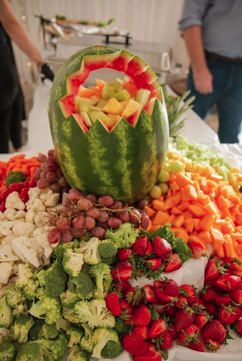 Carved watermelon fruit and vegetable display on the Sweet 16 buffet table