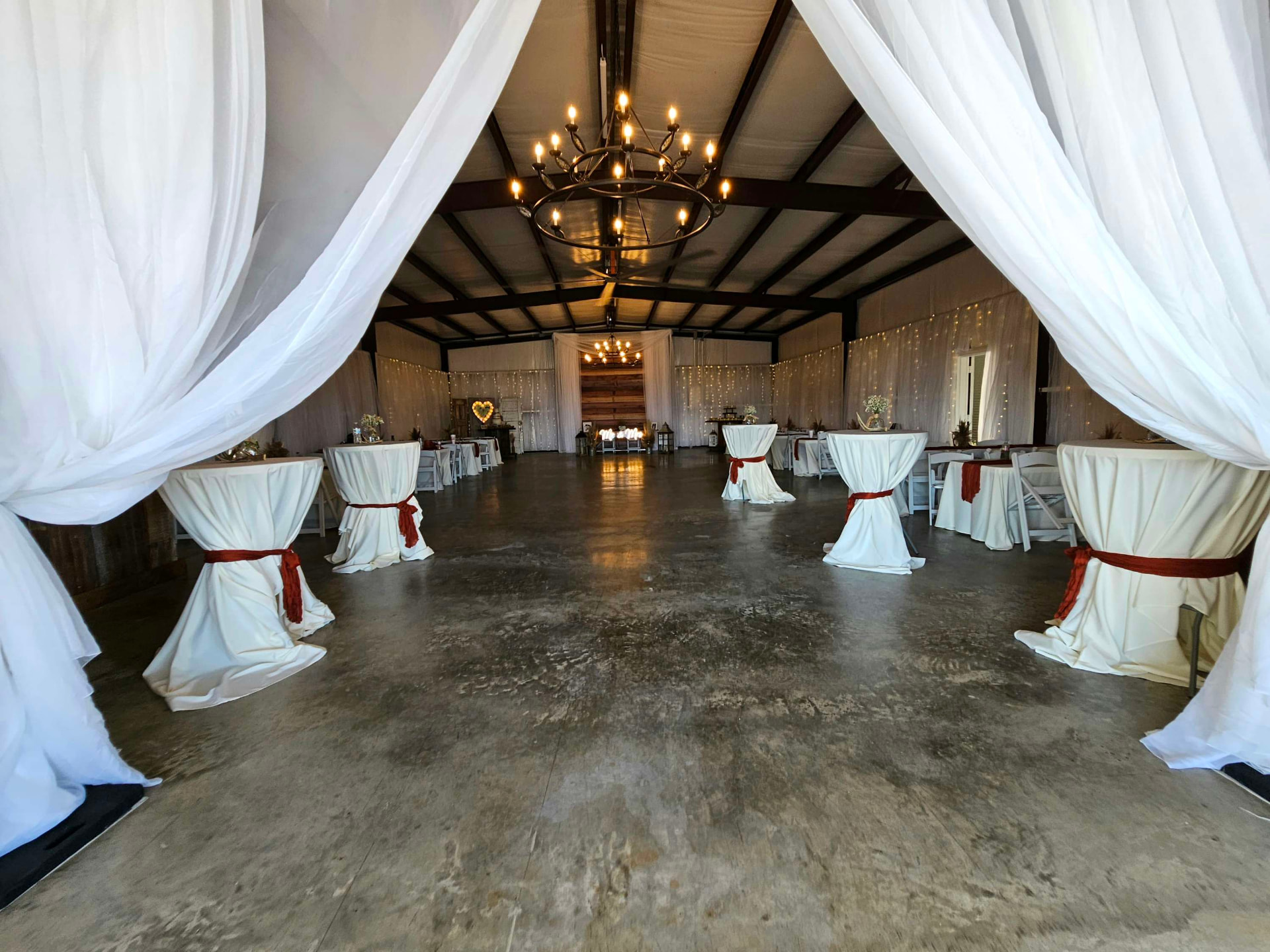 Draped barn entrance couples walk through on a wedding venue tour at Reverie at Diamond D