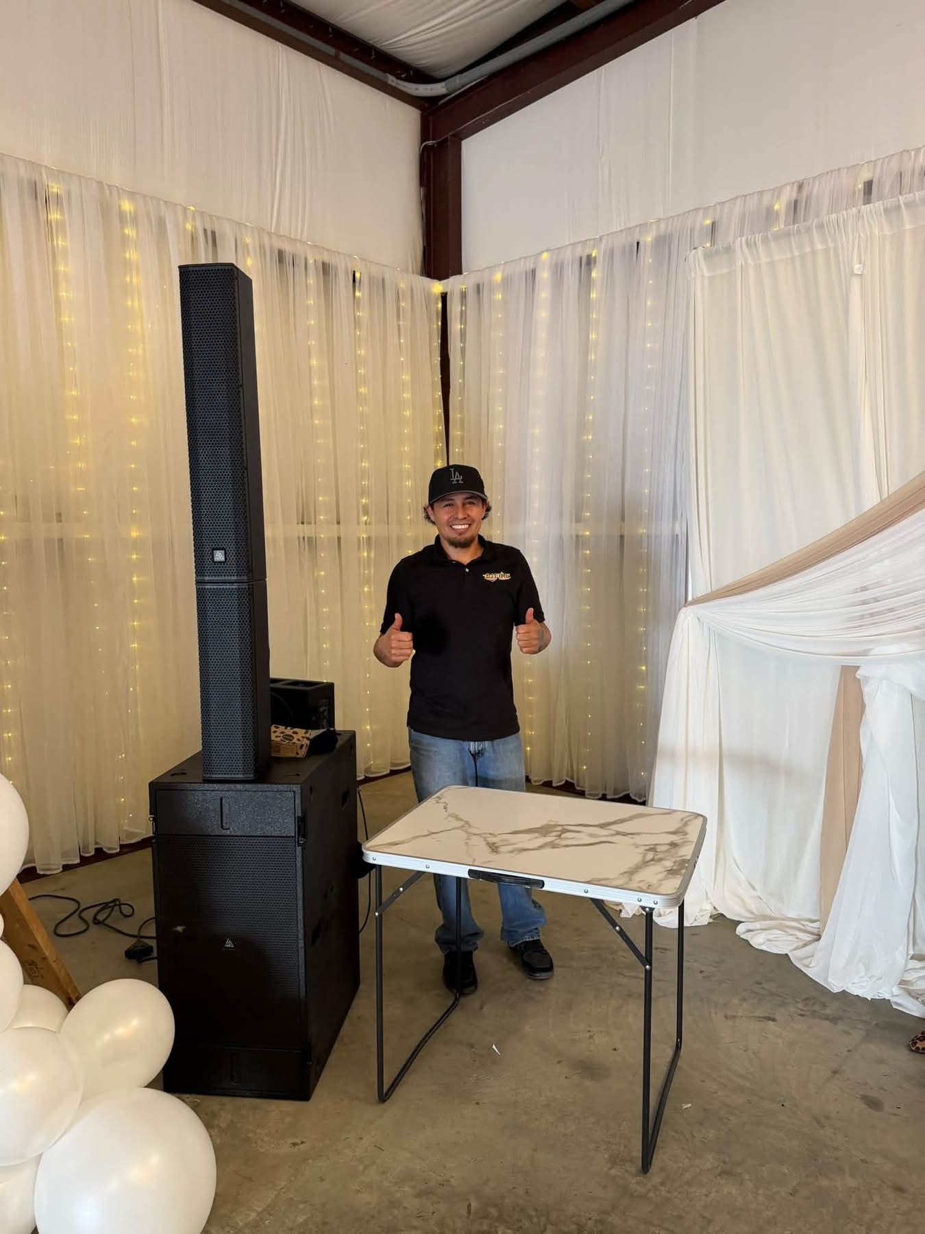 October 2026 Open House at Reverie at Diamond D wedding venue in Normangee, Texas — a DJ setup with a professional speaker stack inside the barn