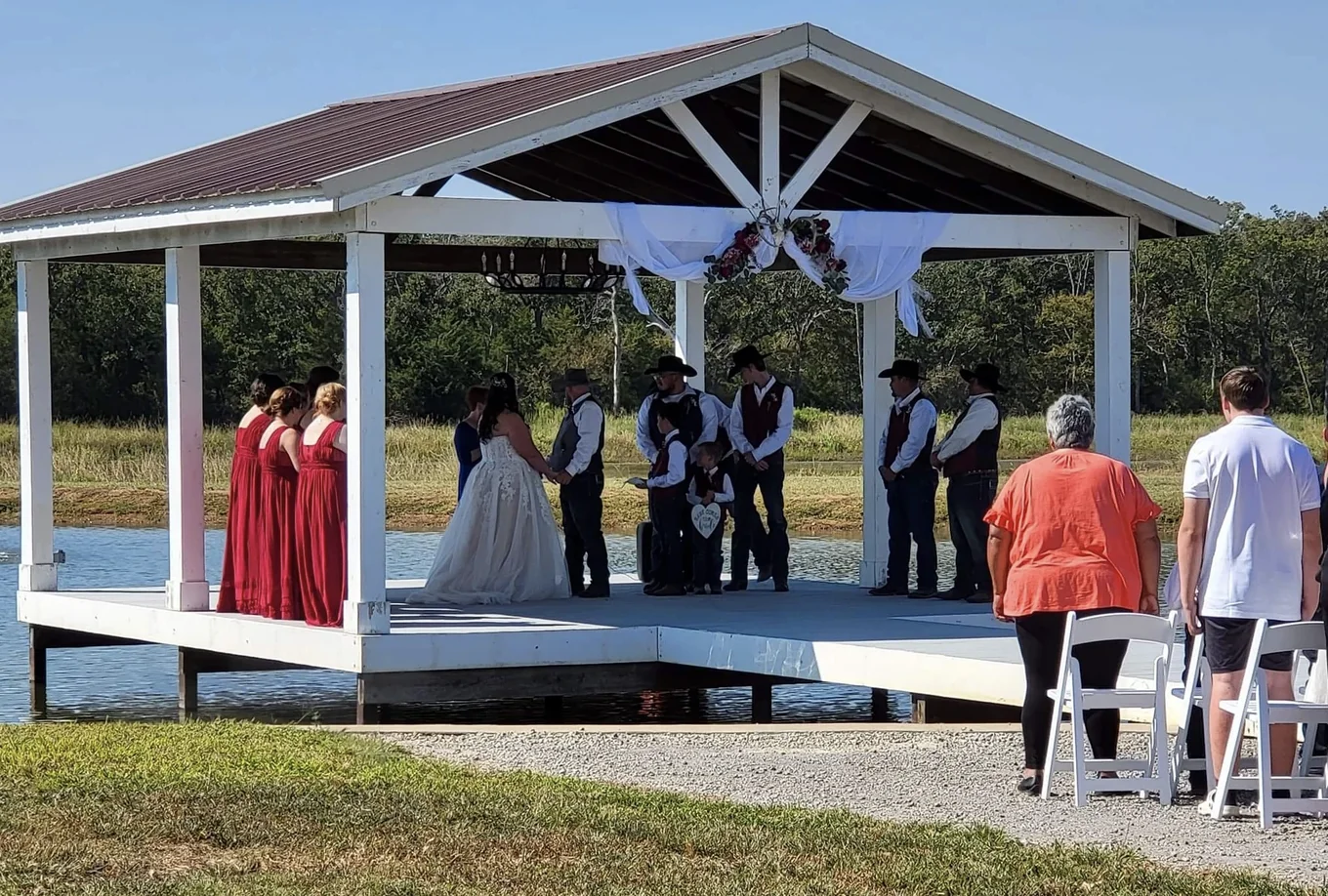 Cole and Emily's outdoor wedding ceremony on the lakeside pavilion at Reverie at Diamond D in Normangee, Texas