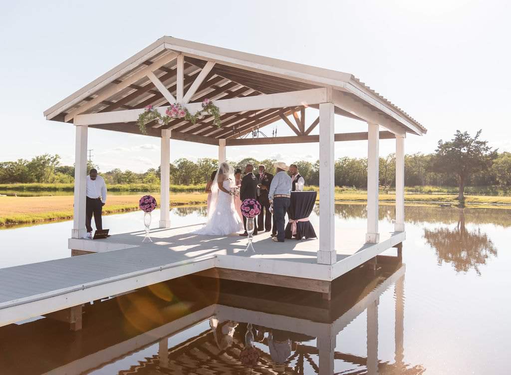 Covered pavilion reflected in the stocked lake at Reverie at Diamond D near Huntsville, Texas